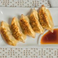 Gyoza (5 pcs) · Marinated pork and vegetable dumplings, pan fried or steamed. Served with special house dump...