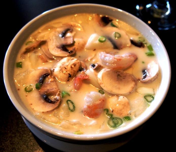 Tom Kha · Fresh spice and herb in light coconut milk soup base with white mushrooms, yellow onion, green onions and lime juice.