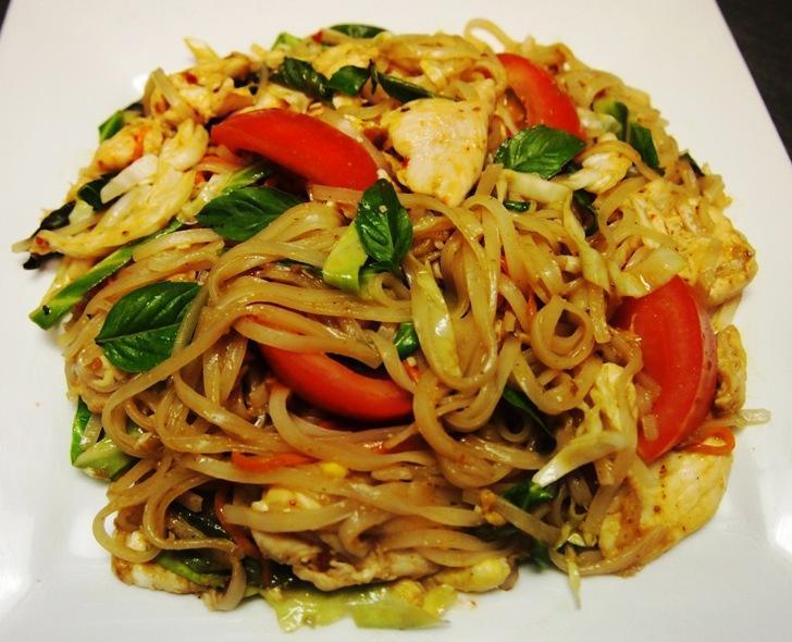 Pad Kee Mao · Rice noodles stir-fried with egg, carrots, cabbages, tomatoes, and sweet basil leaves.