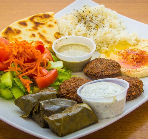 #18 Vegetarian Mix · Pita, hummus, falafel, rice, salad and grape leaves.
