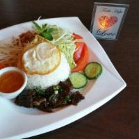 40. Com Thit Nuong Plate · Steamed rice place with a choice of meat with tomatoes, cucumber and lettuce. Served with nu...