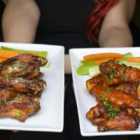 Wings · Tossed with sauce of choice, served with celery and carrot sticks.
