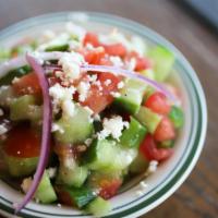 Greek Salad · Chopped cucumbers, tomatoes, red onions, feta cheese and our house vinaigrette dressing. Veg...