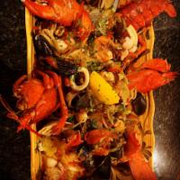 Paelha Valenciana · Made fresh with clams, mussels, shrimp, squid, scallops, lobster, sausage and chicken over s...