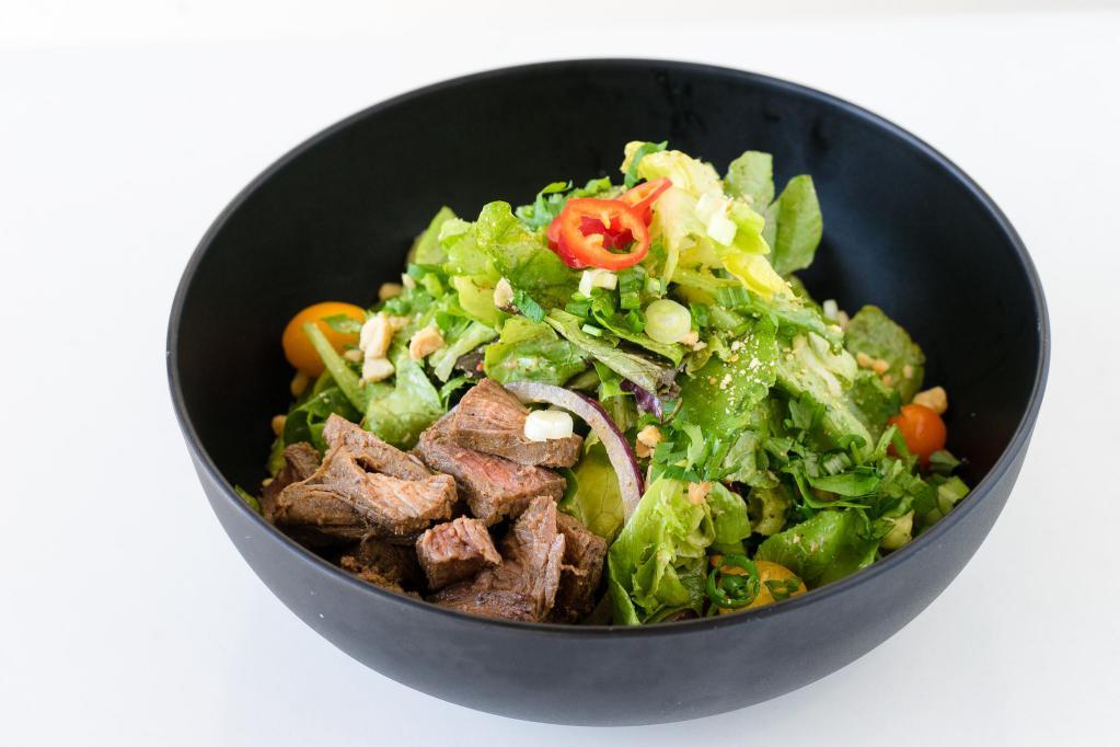 Thai Girl · Butter lettuce, spring mix, chilly cilantro dressing, cherry tomato, red onions, cucumber, cilantro, flank steak, peanuts, scallion and red chili pepper.