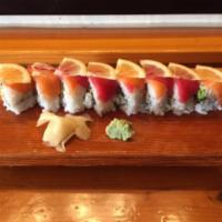 Pink Dragon Roll · Unagi and avocado roll topped with salmon and tuna. Garnished with lemon slices.