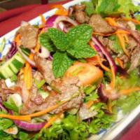 14. House Grilled Beef Salad · Sliced grilled beef with onions, cucumbers, cilantro and tomatoes in a spicy lime sauce.