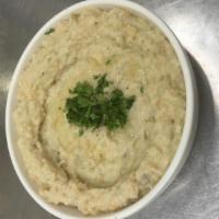 Baba Ghanoush · Mashed grilled eggplant mixed with tahini sauce, lemon juice and garlic. Topped with extra v...