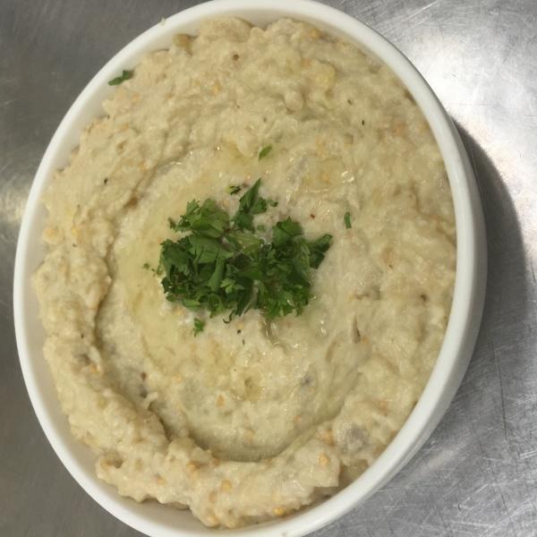 Baba Ghanoush · Mashed grilled eggplant mixed with tahini sauce, lemon juice and garlic. Topped with extra virgin olive oil.
