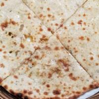 Garlic Naan · White flour bread filled with sauteed garlic and baked in clay oven. 