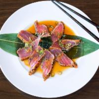 Pepper Tuna · House made peppered & seared tuna, over daikon. Topped w/ ponzu sauce.