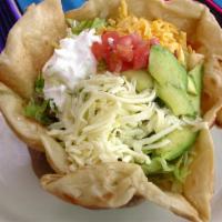 Taco Salad · Choice of seasoned chicken or ground meat on a bed lettuce with guacamole, tomatoes, sour cr...