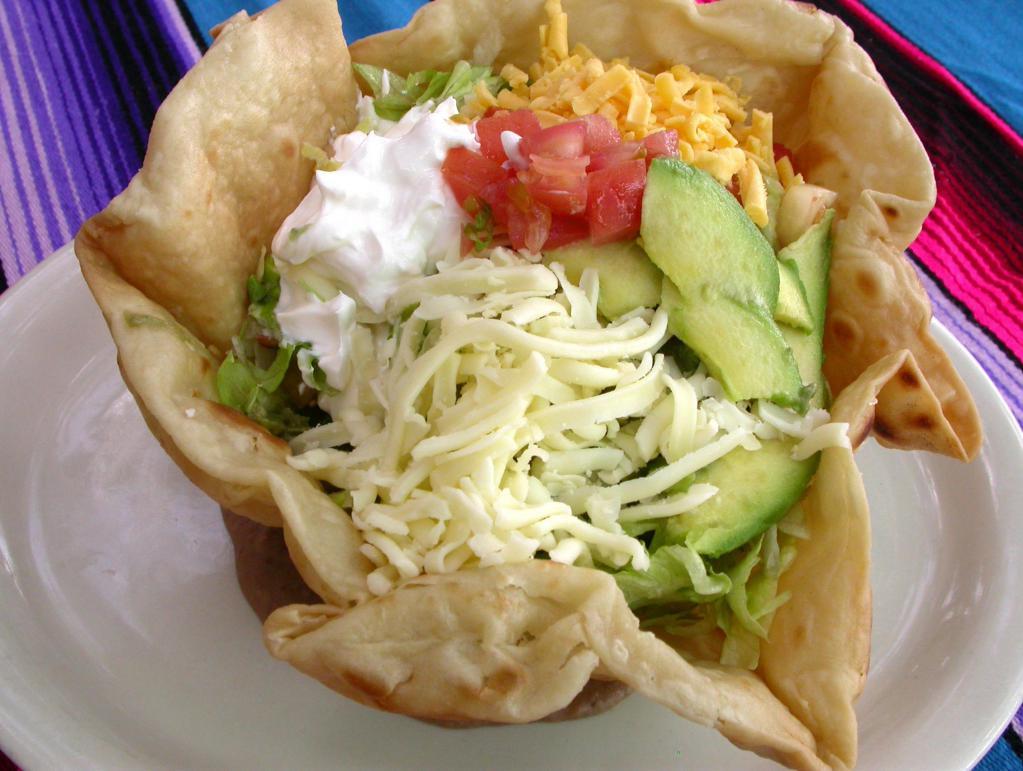 Taco Salad · Choice of seasoned chicken or ground meat on a bed lettuce with guacamole, tomatoes, sour cream and shredded cheese in a crispy tortilla shell. 