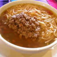 Sopa De Fideo · Fideo, round beans and ground meat. 