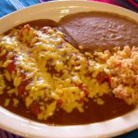 Queso Enchilada · Three traditional cheese enchiladas in sauce. Served with rice, refried beans and corn or fl...