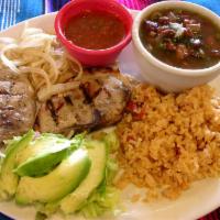 Pork Chop Plate · Two grilled pork chops served with grilled onions, rice, refried beans and salsa ranchera on...