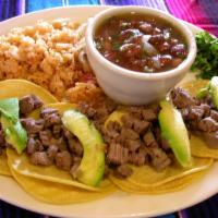 Tilo's Taco Callejeros · Four corn tortillas filled with asada, diced onions and cilantro on the side. Served with ri...