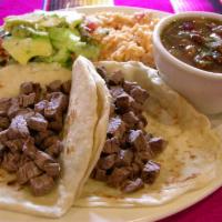 Tacos Al Carbon Fajita · Two charbroiled chopped beef tacos. Served with rice, charro beans, pico de Gallo, guacamole...
