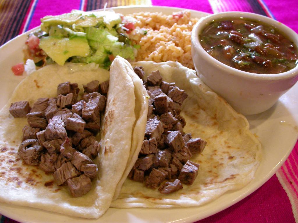 Tacos Al Carbon Fajita · Two charbroiled chopped beef tacos. Served with rice, charro beans, pico de Gallo, guacamole and homemade tortillas.