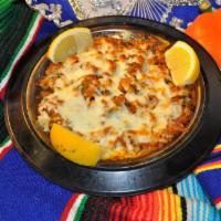 Queso Charro · Homemade chorizo and queso dip. Served on a hot plate.