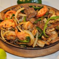 Fajitas Combo · Shrimp, chicken, steak, sauteed onions, tomatoes, green pepper. Served with lettuce, sour cr...