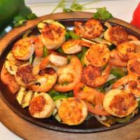 Fajitas Del Mar · Grilled jumbo shrimps, scallops, bell pepper, onions and zucchini. Served with rice, beans, ...