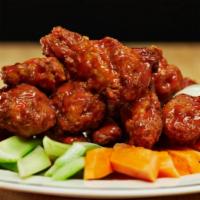 Buffalo Wings · Smothered in House Made Spicy Sauce,Carrots and celery sticks with bleu cheese dressing.