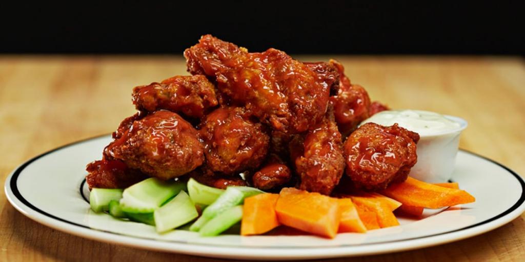 Buffalo Wings · Smothered in House Made Spicy Sauce,Carrots and celery sticks with bleu cheese dressing.