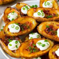 Potato Skins · Topped with melted cheddar, chopped bacon and onions, served with sour cream and a sprinkle ...