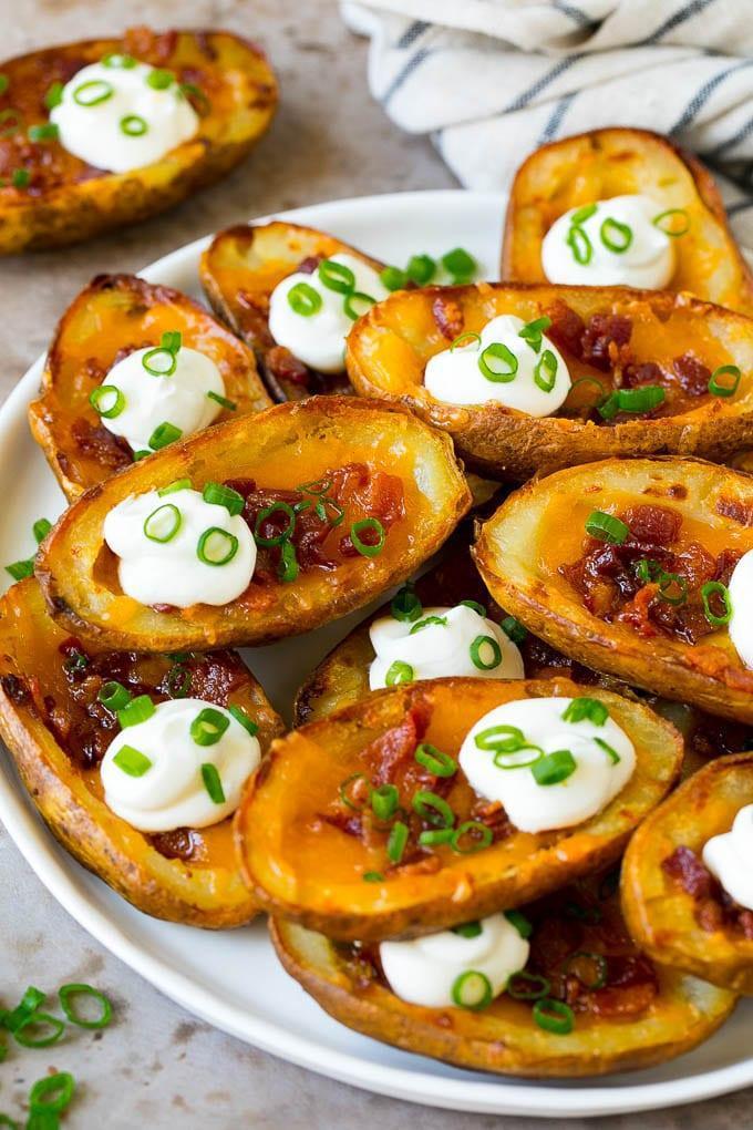 Potato Skins · Topped with melted cheddar, chopped bacon and onions, served with sour cream and a sprinkle of parsley.