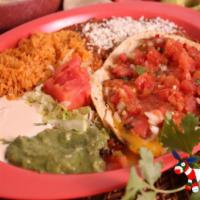 Huevos Rancheros · 2 fried eggs served on lightly fried corn tortillas topped with a tomato-chili sauce. Served...