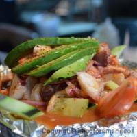 Molcajete Diablillo · Priced per large. Comes with shrimp, octopus, scallops, clams oyster and vegetables in a spi...