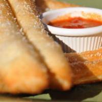 Breadsticks · Brushed with garlic sauce, topped with Parmesan cheese and served with marinara.
