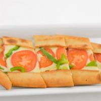 Cheese Pide with Tomato Slices and Pepper · Crispy crust of dough topped with Turkish kassari cheese.