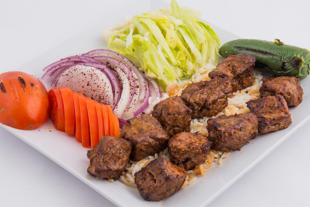Beef Shish Kebab · Chunks of beef marinated in our special sauce and grilled over charcoal skewers. Served with rice, lettuce, onions and tomatoes. 