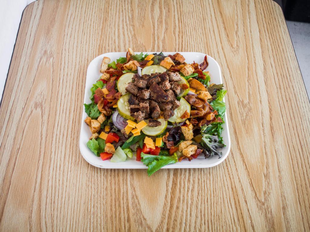 Bacon Cheeseburger Salad · Spring mix and romaine lettuce with bacon, ground beef, onions, pickles, shredded cheddar and Russian dressing.