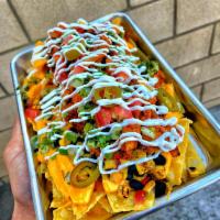 Loaded Nachos · Won ton nachos, roasted corn, black beans, nacho cheese, shredded chicken, jalapenos, pico d...