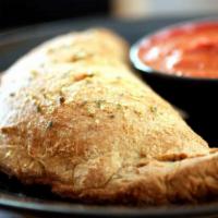 Calzone · Made with chewy NY style dough. Comes with a cheese and 1 filling.  Red sauce inside or on t...