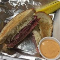 Sammy T's Classic Reuben · Corned Beef Sandwich with Rye Bread, Thousand Island Dressing, Sauerkraut with a pickle & dr...