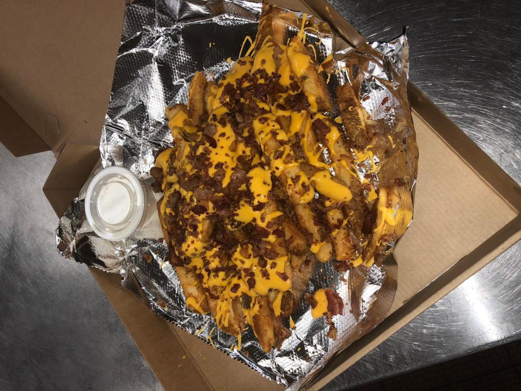 Sammy T's Loaded Bacon Fries · Our seasoned fries loaded with cheese and bacon. Very generous size.