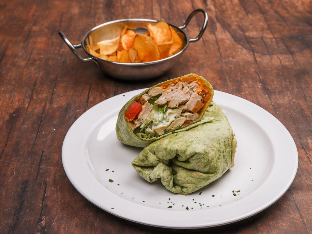Chicken Spinach Wrap · Fried or grilled chicken diced tomatoes, lettuce and cheddar cheese wrapped in a spinach tortilla. Served with homemade chips.