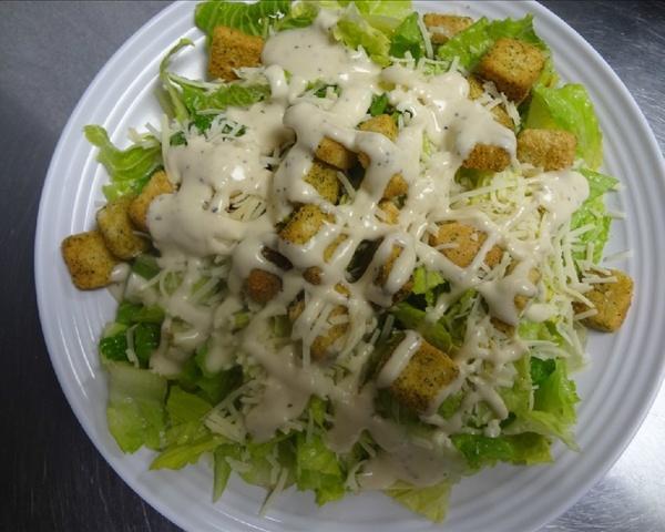 Caesar Salad · Tender hearts of romaine tossed with our special Caesar dressing. Served with Romano, Parmesan and garlic croutons.