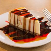 New York Cheesecake · Creamy cheesecake on a graham cracker crust. Served with your choice of chocolate or raspber...