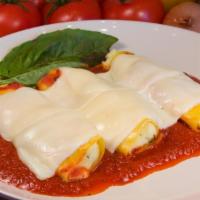 Baked Manicotti · Tube shaped pasta stuffed with ricotta cheese and our homemade marinara sauce, topped with m...