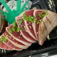 Tuna Tataki Appetizer · Thinly-sliced seared tuna with spicy ponzu sauce.