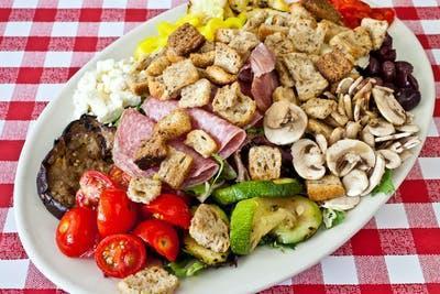 The Antipasto Salad · Mixed greens, assorted cold cuts, hot peppers, provolone and grilled vegetables topped with olive oil and red wine vinegar.