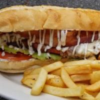 Chicken Bacon Ranch Grinder · Fried chicken cutlet, slab bacon and ranch dressing with lettuce and tomato on a grinder rol...