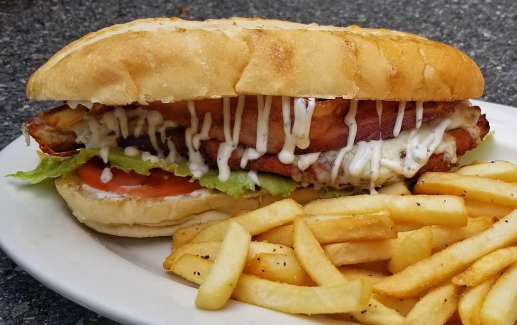 Chicken Bacon Ranch Grinder · Fried chicken cutlet, slab bacon and ranch dressing with lettuce and tomato on a grinder roll- Fries not included