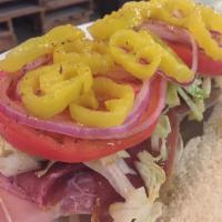 Italian Grinder · Prosciutto, salami, provolone cheese, lettuce, tomato, onions and banana peppers. Served on ...