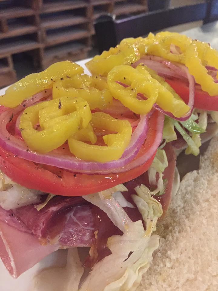 Italian Grinder · Prosciutto, salami, provolone cheese, lettuce, tomato, onions and banana peppers. Served on a fresh torpedo roll.